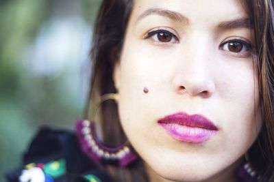 Close-up portrait of young woman wearing make-up