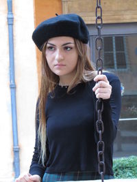 Portrait of young woman wearing hat
