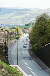 High angle view of street amidst trees against sky