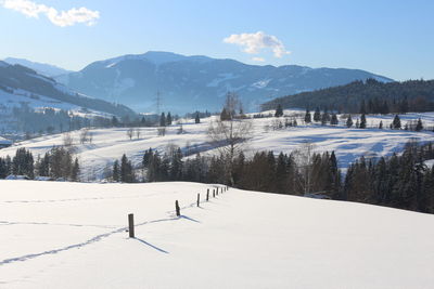 Snow covered landscape against sky