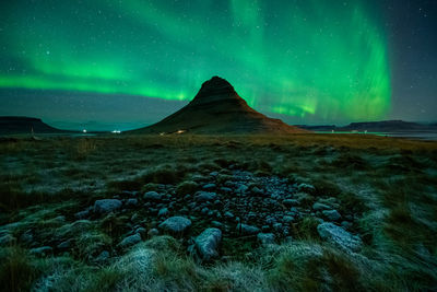 Scenic view of snowcapped mountains against sky at night