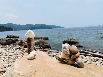 Rocks on beach against sky
