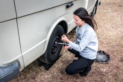 Full length of woman standing by car