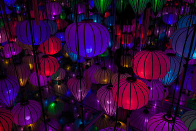 Low angle view of illuminated lanterns hanging at night