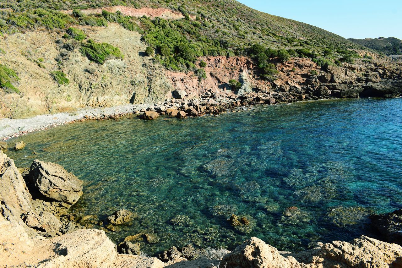 nature, beauty in nature, rock - object, water, tranquility, scenics, tranquil scene, no people, sea, outdoors, landscape, mountain, day, clear sky, sky