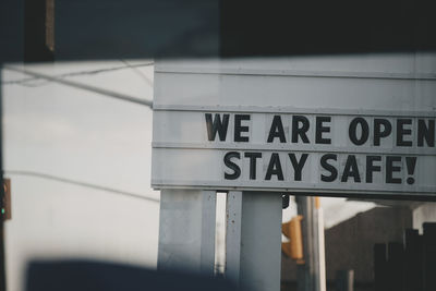 Outdoor sign telling people to stay safe.