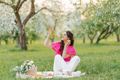 Picnic of a young beautiful woman in the spring garden outdoors person