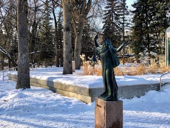 Statue in park during winter