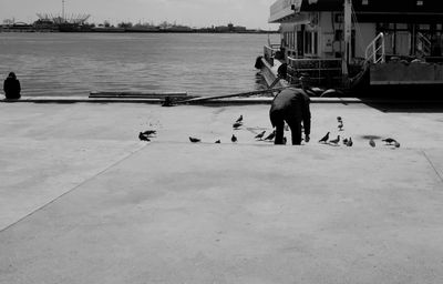 Rear view of people on boat in sea
