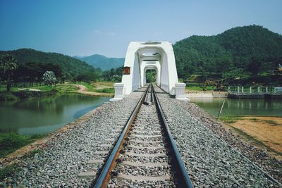 High angle view of railroad tracks by mountain against sky