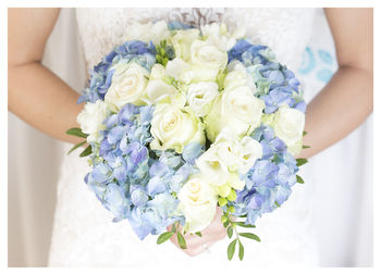 Midsection of woman holding flower bouquet