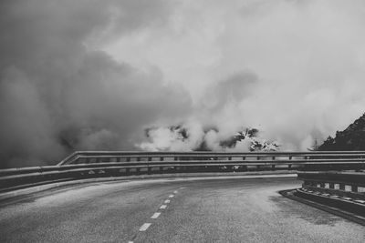 Road by bridge against sky