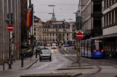 Road sign and vehicles on street in city