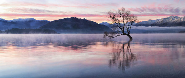 Scenic view of lake against sky during sunset