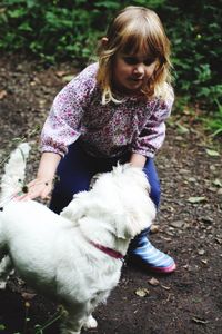 Cute girl playing with dog