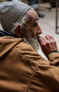 Close-up of man relaxing on wall