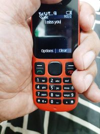 Close-up of hand holding mobile phone