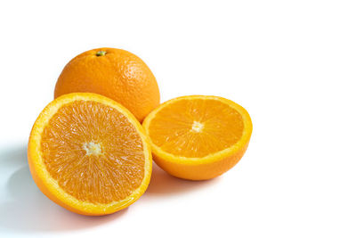 Close-up of orange fruit against white background