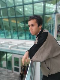 Portrait of young man looking at window