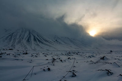 Scenic view of snow covered mountains against sky