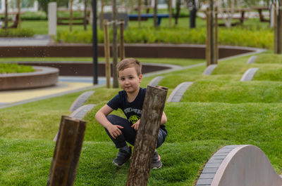 Portrait of boy sitting on grass