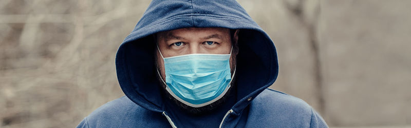 Portrait of man wearing mask standing outdoors