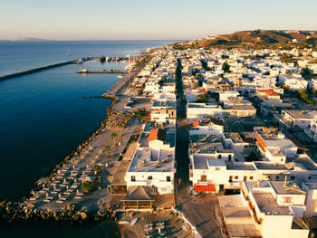 High angle view of townscape by sea against sky