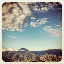 Scenic view of mountains against cloudy sky