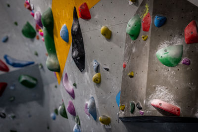 Close-up of multi colored grips on wall