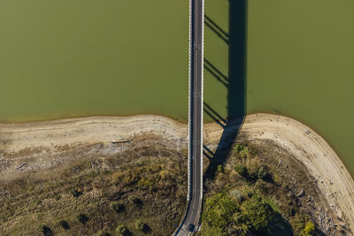 Aerial view of a road driving along the lake corbara, baschi, umbria, italy.