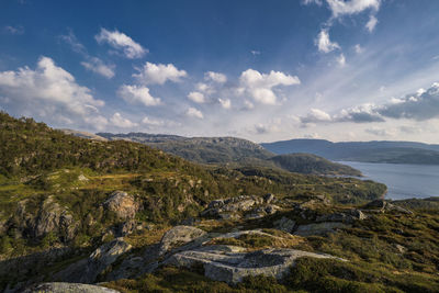 Scenic view of sea and mountains against sky