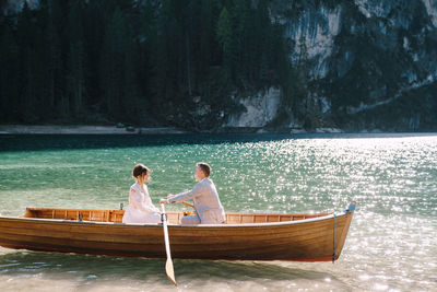 Rear view of couple on boat at sea