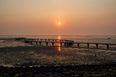 Scenic view of beach against sky during sunset