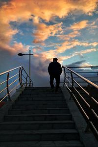 Silhouette man walking on stairs