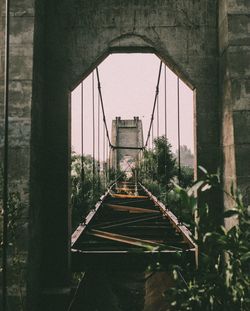 Bridge in city against sky