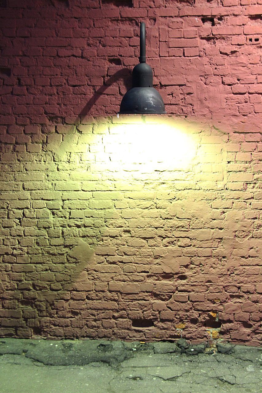 CLOSE-UP OF ILLUMINATED LAMP ON WALL