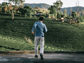 Rear view of man standing on field