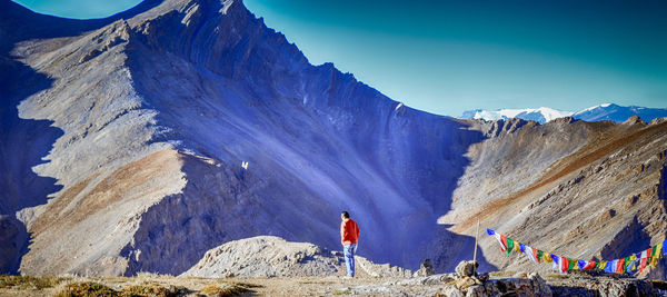 Rear view of man standing against mountain at leh