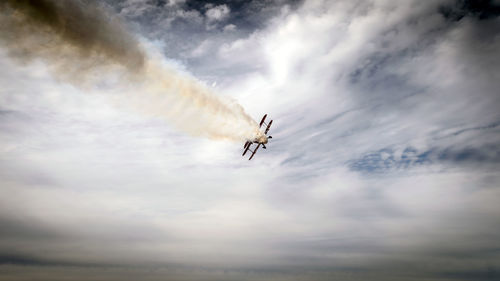 Low angle view of airplane flying in sky