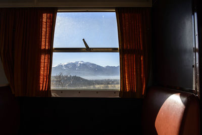 Scenic view of mountains seen through train window