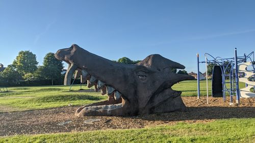 View of horse statue on field against sky