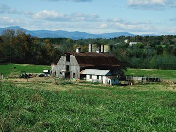 Houses on field against sky