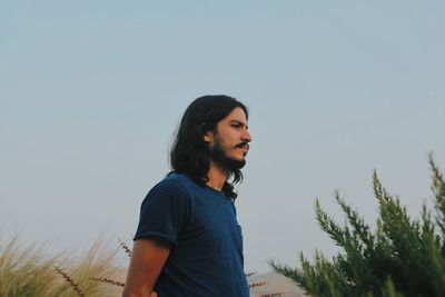 Portrait of young man standing outdoors