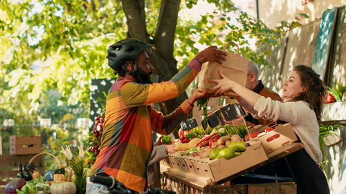 Rear view of woman with vegetables at market