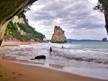 Scenic view of beach against cloudy sky