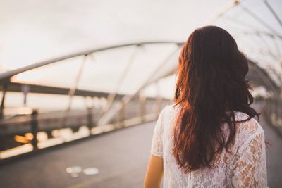 Rear view of woman on bridge