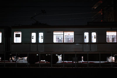 Train at railroad station platform at night
