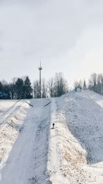 Snow covered field against sky