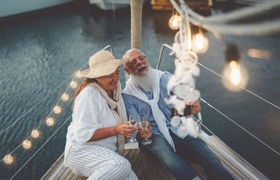 Couple and sitting on boat in sea