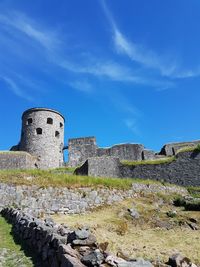 Old ruin building against blue sky